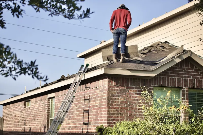 Professional roofer working on a residential roof in Chevy Chase Section 4